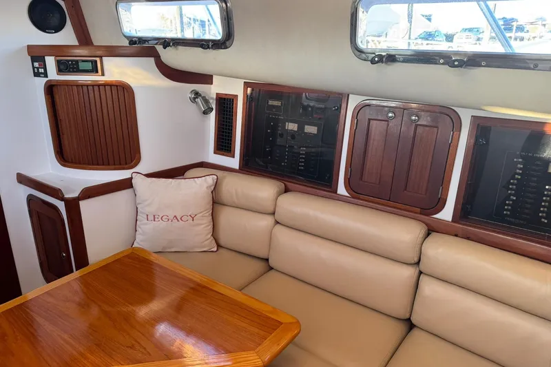 Pilgrim Yacht Photos Pics Interior of 2001 Legacy Soft Top boat with beige seating and wooden accents.