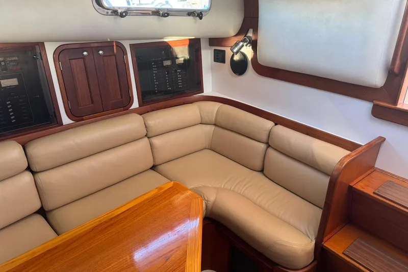 Pilgrim Yacht Photos Pics Luxurious 2001 Legacy Soft Top yacht interior with beige leather seating and wooden accents.