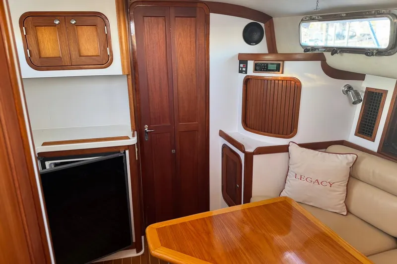 Pilgrim Yacht Photos Pics Interior of 2001 Legacy Soft Top boat with wood accents and seating area.