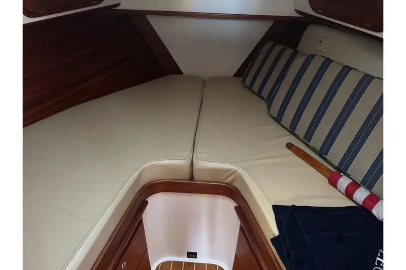 Pilgrim Yacht Photos Pics 2001 Legacy Soft Top boat interior with cushioned seating and striped pillows.