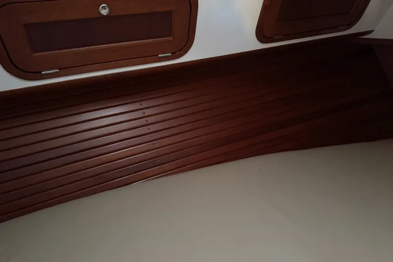 Pilgrim Yacht Photos Pics Interior of 2001 Legacy Soft Top boat with wooden paneling and storage compartments.