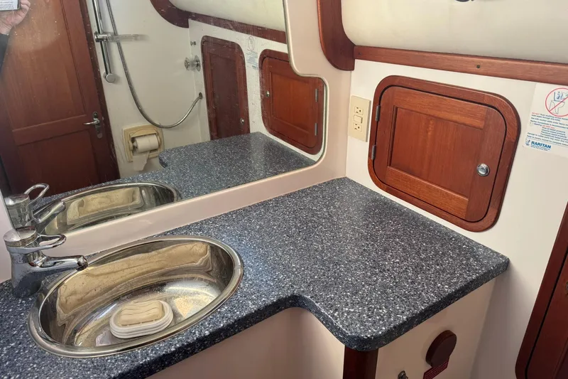 Pilgrim Yacht Photos Pics 2001 Legacy Soft Top bathroom with stainless steel sink, wooden cabinets, and granite countertop.