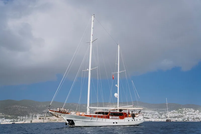 Yacht Photos Pics Custom 30M Gulet sailing on calm waters under a cloudy sky, 2005 model.