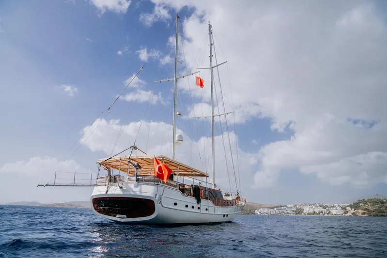  Yacht Photos Pics 30-meter custom-made gulet sailing on the sea, 2005 model, under a partly cloudy sky.
