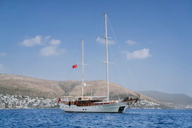  Yacht Photos Pics Custom 30M gulet sailing on blue waters, coastal hills in background, 2005 model.