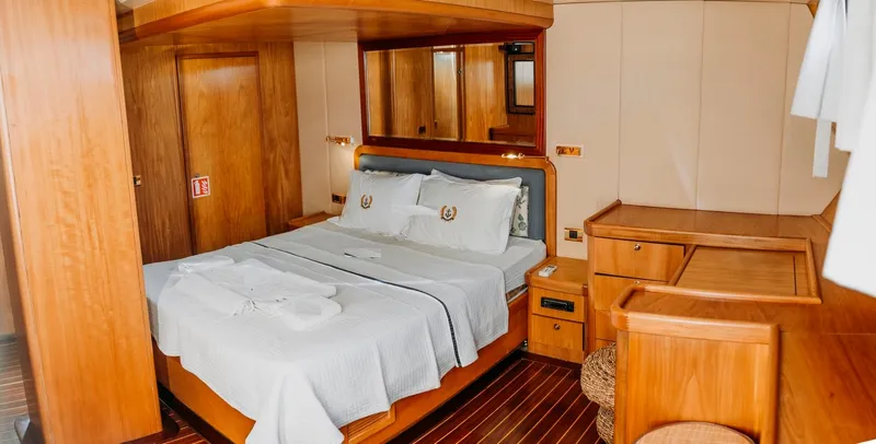  Yacht Photos Pics Luxurious wooden cabin interior on a 2005 custom-made gulet yacht with a cozy bed.