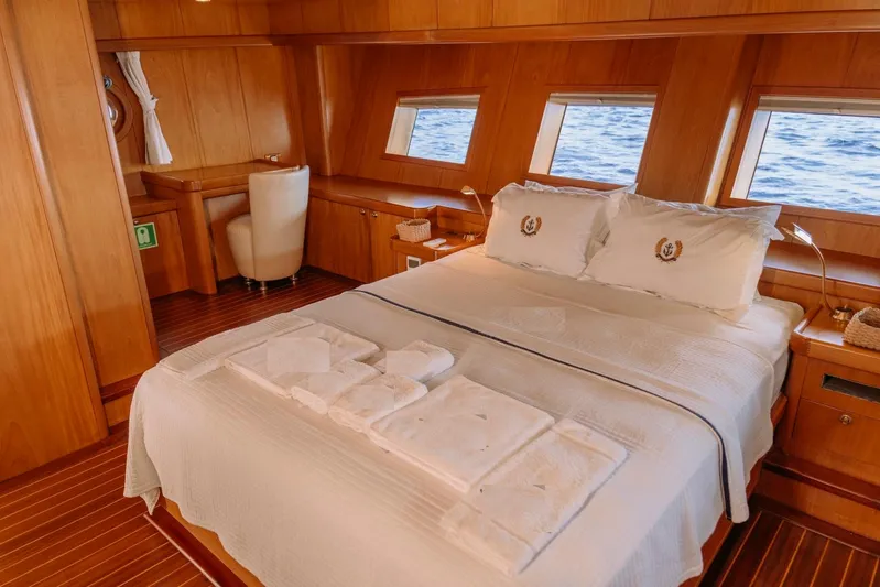  Yacht Photos Pics Luxurious cabin interior of 30M Custom Made Gulet, featuring a cozy bed and ocean view.