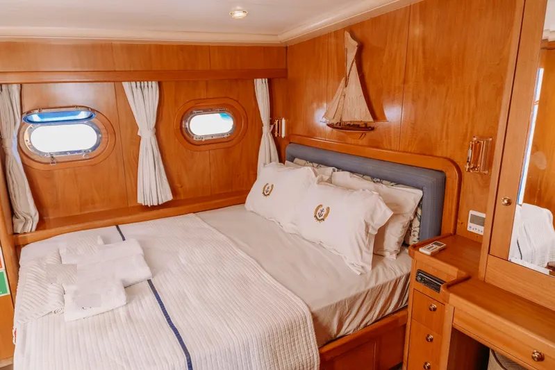  Yacht Photos Pics Luxurious cabin interior of 2005 Custom 30M Gulet with wooden decor and cozy bedding.