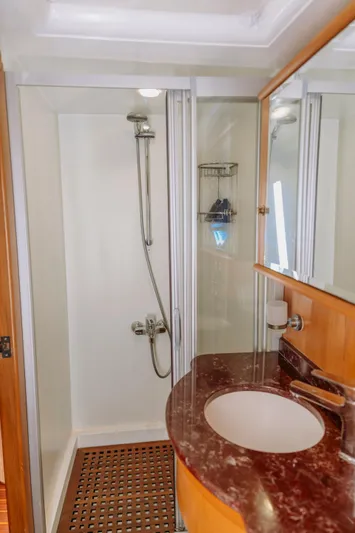  Yacht Photos Pics Luxurious bathroom on a 2005 custom-made gulet, featuring a modern shower and elegant sink.