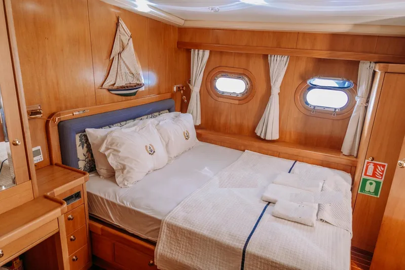  Yacht Photos Pics Luxurious cabin interior of 2005 Custom 30M Gulet with nautical decor and porthole windows.
