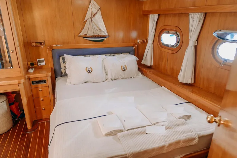  Yacht Photos Pics Luxurious cabin interior of 2005 Custom 30M Gulet with nautical decor and cozy bedding.
