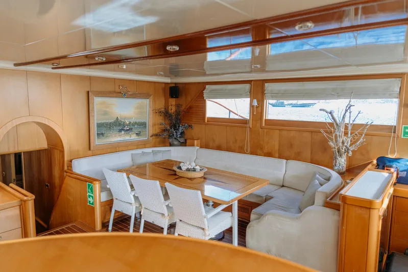  Yacht Photos Pics Luxurious interior of a 2005 custom-made gulet with elegant dining area and wooden finishes.
