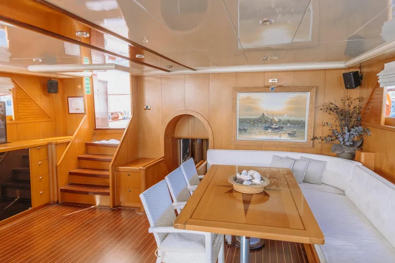  Yacht Photos Pics Luxurious interior of 2005 custom-made gulet with wooden decor and elegant seating area.