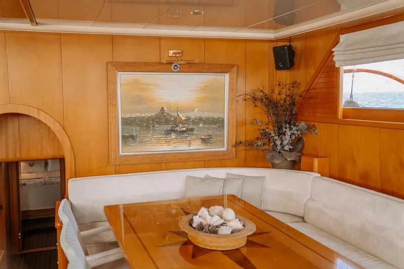  Yacht Photos Pics Luxurious interior of 2005 custom-made gulet with elegant wood paneling and nautical artwork.