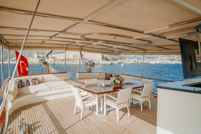  Yacht Photos Pics Luxurious 30M custom gulet deck with seating, dining area, and Turkish flag, 2005 model.