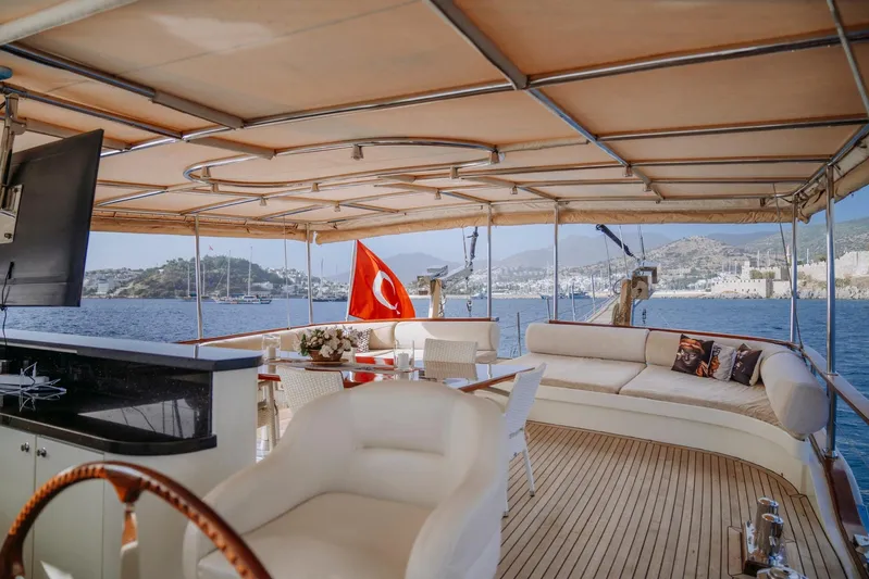  Yacht Photos Pics Luxurious 2005 custom-made gulet with spacious deck, Turkish flag, and scenic sea view.