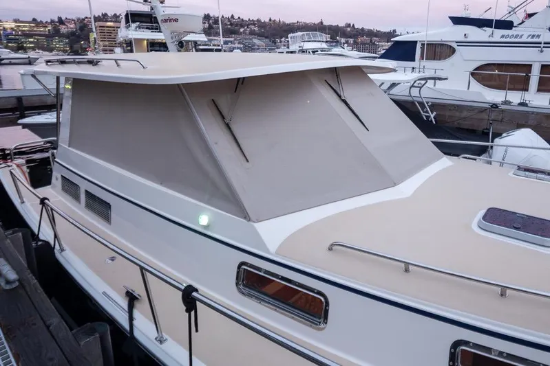 Peddler Yacht Photos Pics 2007 Bruckmann BLUESTAR boat docked at marina during sunset.