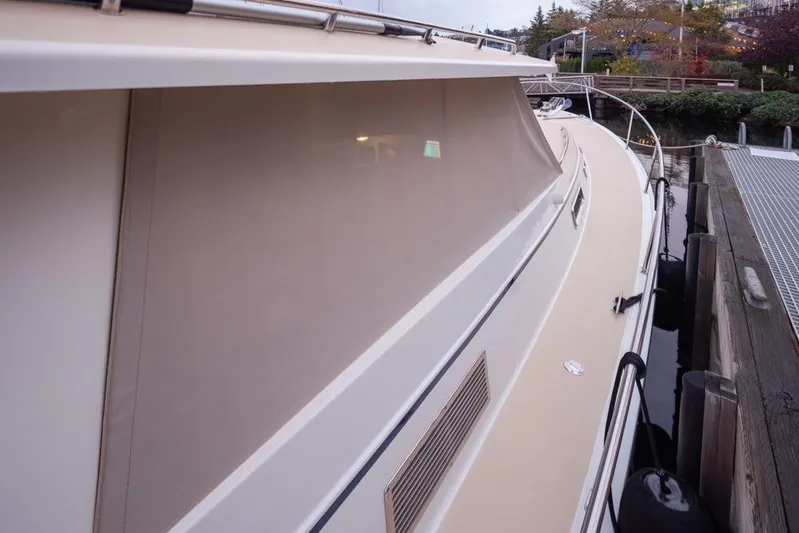 Peddler Yacht Photos Pics 2007 Bruckmann BLUESTAR yacht docked, side view with covered windows and sleek design.