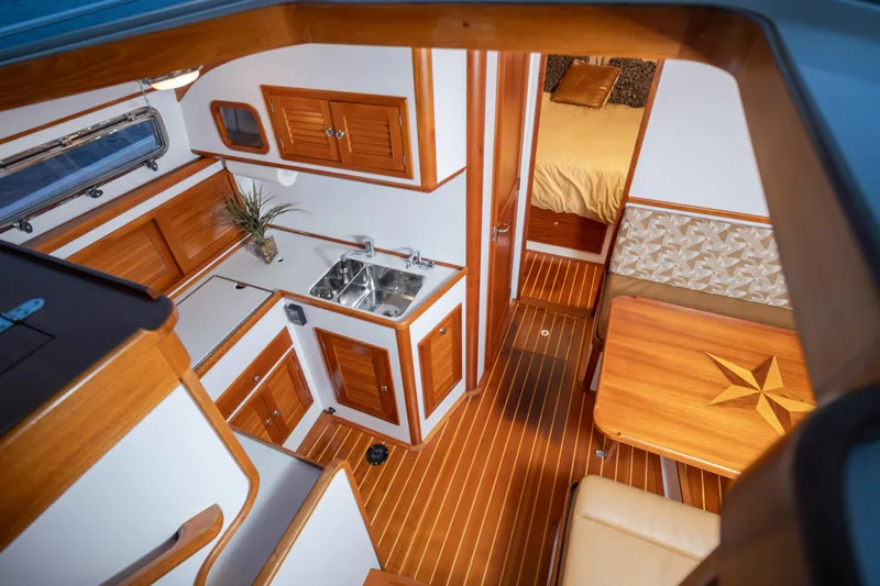 Peddler Yacht Photos Pics Luxurious 2007 Bruckmann BLUESTAR yacht interior with wood finishes and modern amenities.