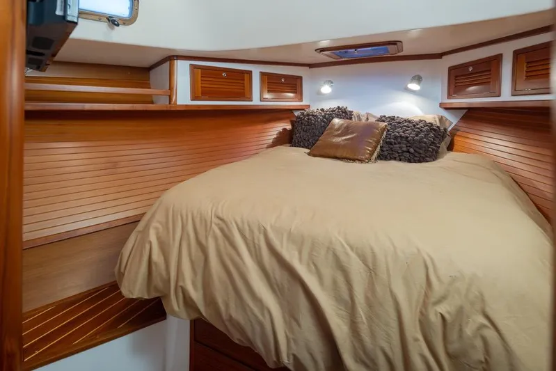 Peddler Yacht Photos Pics Luxurious cabin interior of 2007 Bruckmann BLUESTAR yacht with cozy bedding and wooden accents.