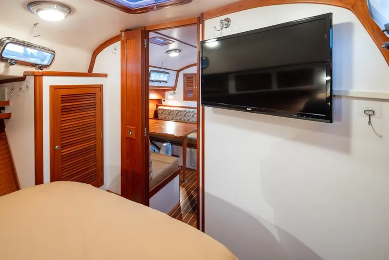 Peddler Yacht Photos Pics Interior of 2007 Bruckmann BLUESTAR yacht with wood accents and mounted TV.