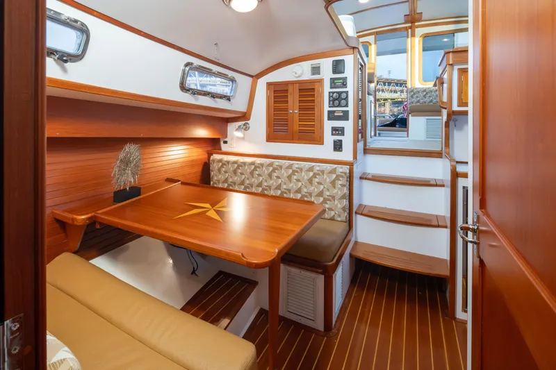 Peddler Yacht Photos Pics Luxurious 2007 Bruckmann BLUESTAR yacht interior with wooden dining area and elegant seating.