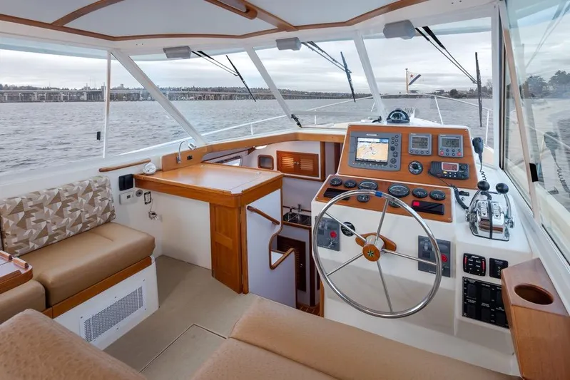 Peddler Yacht Photos Pics Interior of 2007 Bruckmann BLUESTAR boat with steering wheel and navigation equipment.