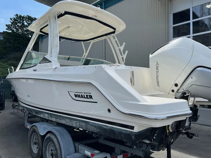  Yacht Photos Pics 2022 Boston Whaler 240 Vantage boat on trailer, featuring Mercury engine.