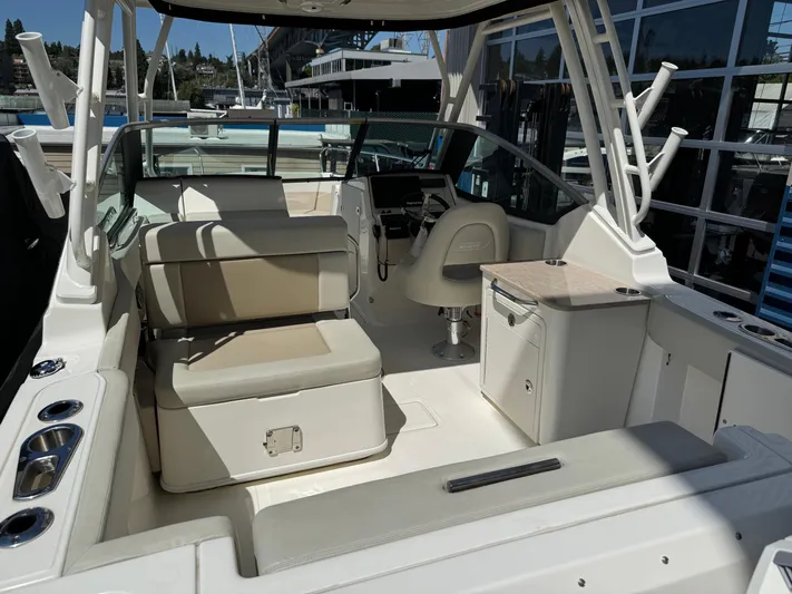  Yacht Photos Pics 2022 Boston Whaler 240 Vantage boat interior with seating and helm station.