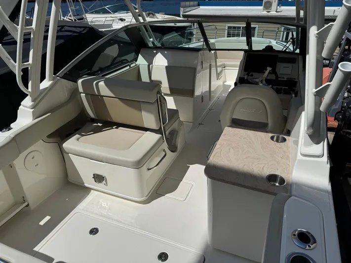 Yacht Photos Pics 2022 Boston Whaler 240 Vantage boat interior with seating and helm station.