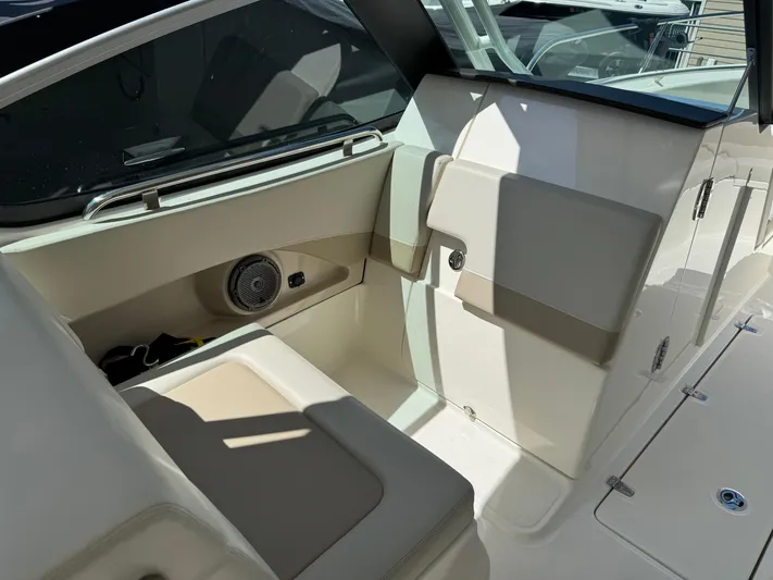  Yacht Photos Pics Interior seating of 2022 Boston Whaler 240 Vantage boat, featuring beige upholstery and speaker.