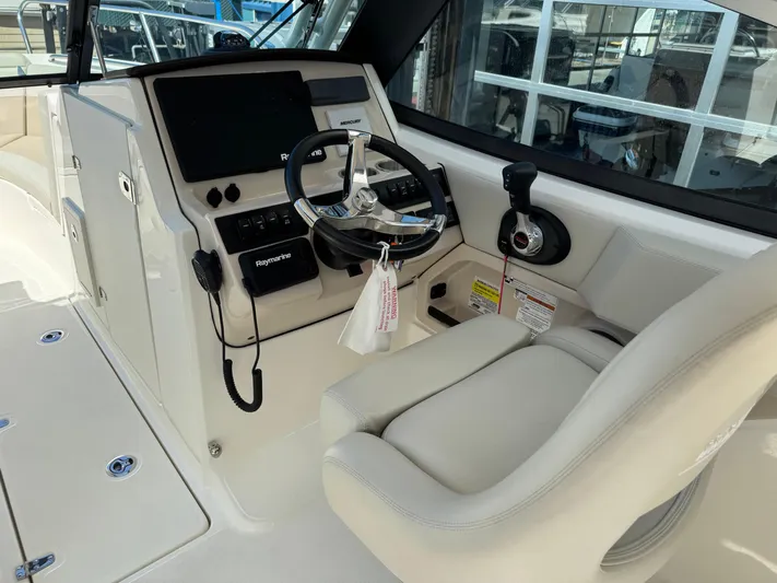  Yacht Photos Pics 2022 Boston Whaler 240 Vantage helm with steering wheel, controls, and Raymarine electronics.
