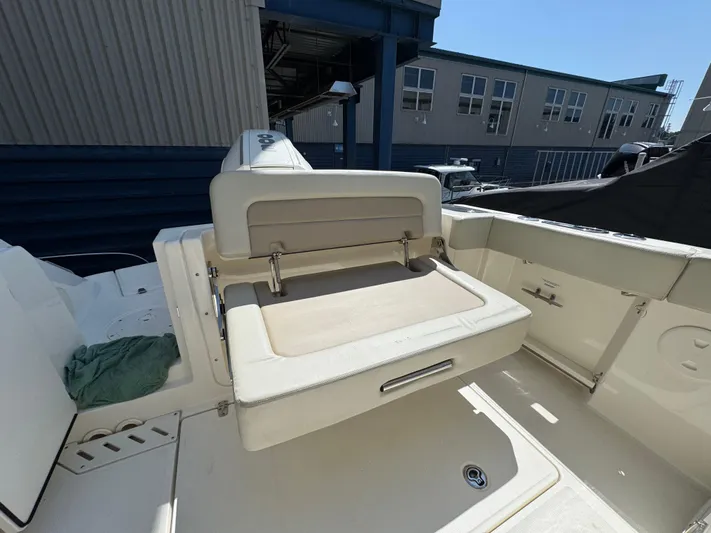  Yacht Photos Pics 2022 Boston Whaler 240 Vantage boat interior with foldable seating and storage.
