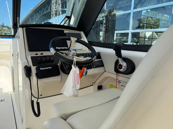  Yacht Photos Pics Interior view of 2022 Boston Whaler 240 Vantage boat cockpit with Raymarine equipment.