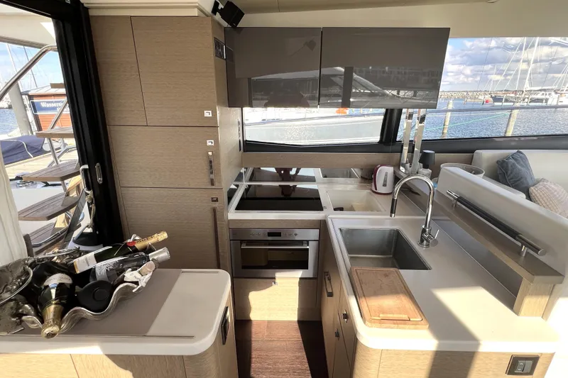 Kuramati III Yacht Photos Pics Luxurious kitchen interior of 2016 Prestige 500 yacht with modern appliances and sea view.