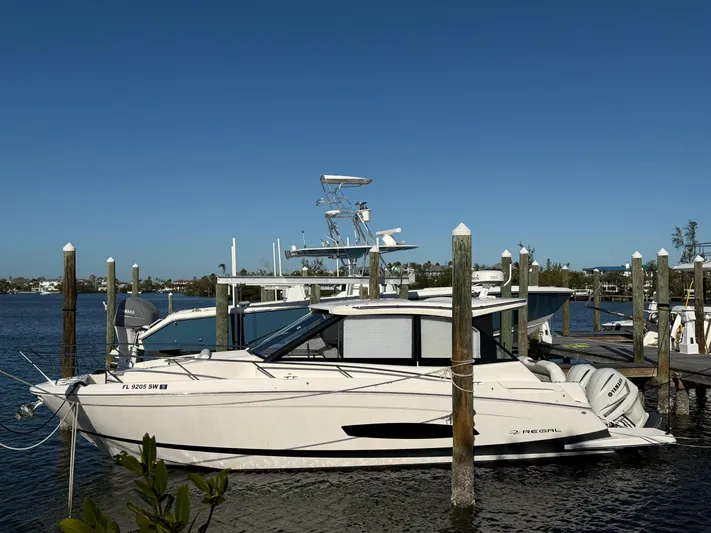  Yacht Photos Pics 2021 Regal 36 XO boat docked at marina under clear blue sky.