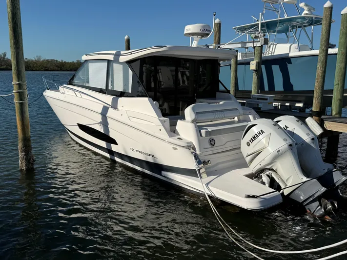  Yacht Photos Pics 2021 Regal 36 XO boat docked, featuring Yamaha outboard engines, in a sunny marina setting.