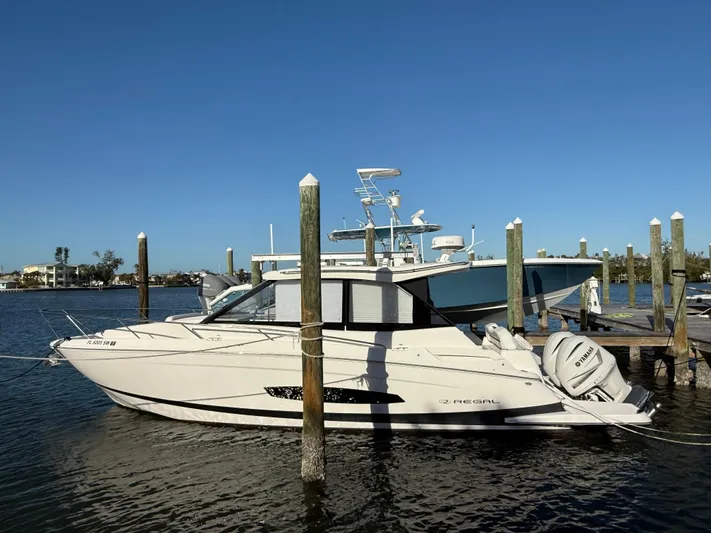  Yacht Photos Pics 2021 Regal 36 XO boat docked in marina under clear blue sky.