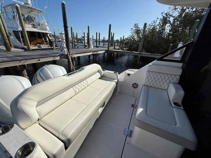  Yacht Photos Pics 2021 Regal 36 XO boat interior with white seating, docked at a marina.