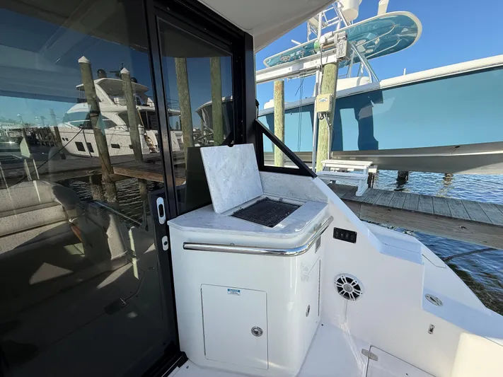  Yacht Photos Pics 2021 Regal 36 XO yacht with outdoor kitchenette and marina view.