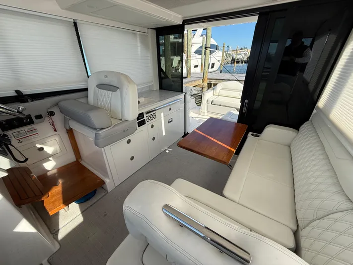  Yacht Photos Pics Luxurious interior of 2021 Regal 36 XO yacht with white seating and wooden accents.