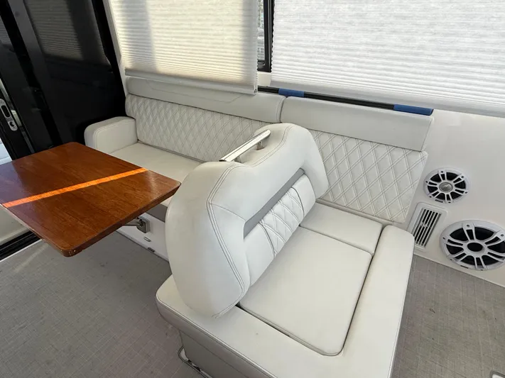  Yacht Photos Pics Luxurious interior seating of 2021 Regal 36 XO yacht with elegant white upholstery.