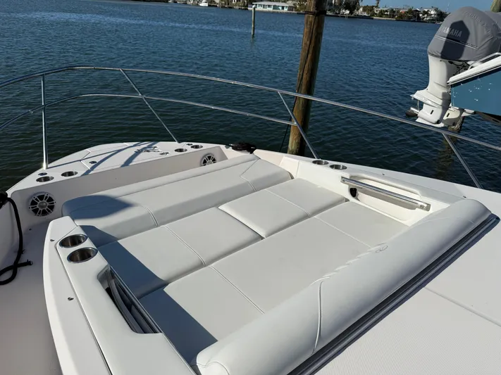  Yacht Photos Pics Luxurious 2021 Regal 36 XO boat with spacious sunbathing deck on calm waters.