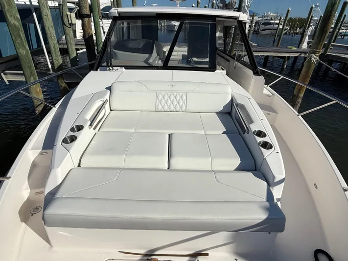  Yacht Photos Pics 2021 Regal 36 XO boat with spacious white seating area at the dock.