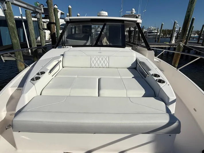  Yacht Photos Pics 2021 Regal 36 XO boat with spacious white seating area at the dock.