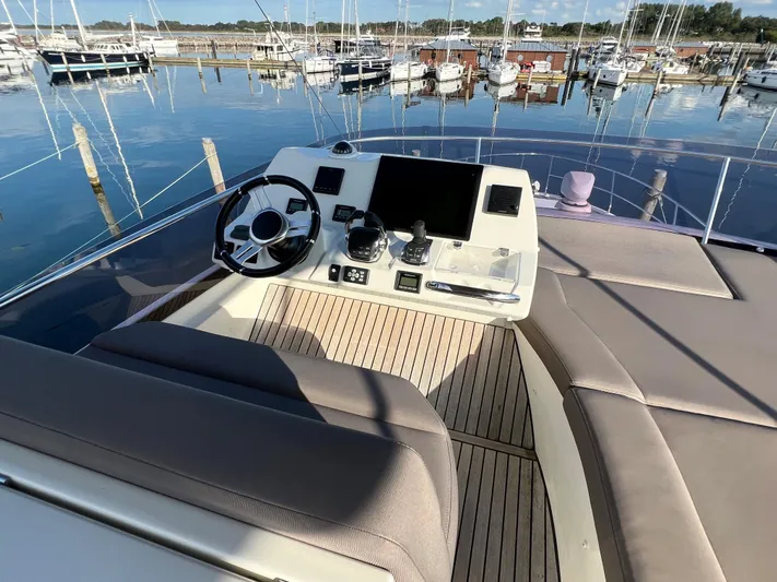 Kuramati III Yacht Photos Pics Flybridge of 2016 Prestige 500 yacht with helm station, overlooking marina.