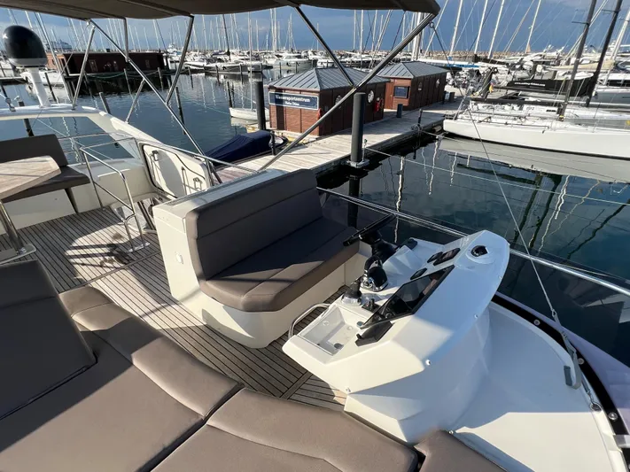 Kuramati III Yacht Photos Pics Flybridge of 2016 Prestige 500 yacht with helm station, seating, and marina view.