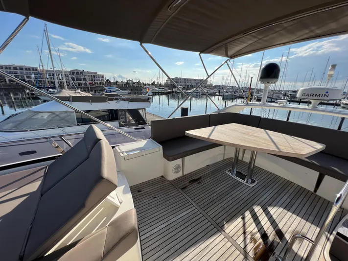 Kuramati III Yacht Photos Pics Luxurious 2016 Prestige 500 yacht with spacious deck seating in a marina setting.