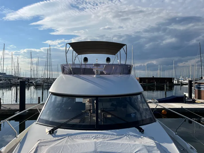 Kuramati III Yacht Photos Pics Prestige 500 yacht docked at marina, 2016 model, under a partly cloudy sky.