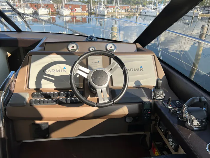 Kuramati III Yacht Photos Pics Cockpit of 2016 Prestige 500 yacht with Garmin navigation system and steering wheel.